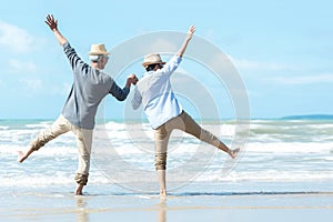 Asian Lifestyle senior couple jumping on the beach happy in love romantic and relax time.Â 